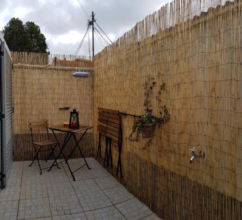 a patio with a table and a fence at O Ninho in Vila Nova de Gaia