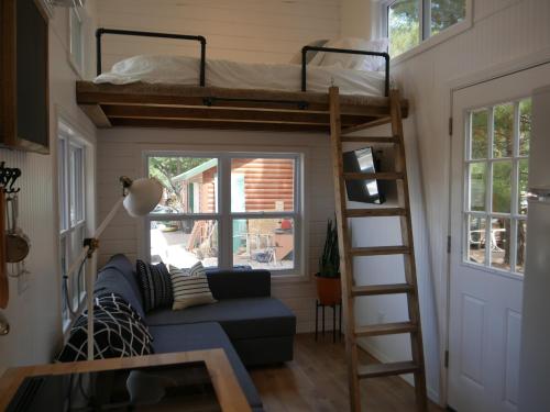 a living room with a couch and bunk beds at Hygge Tiny Home in Leeds