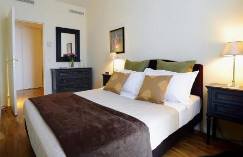 a bedroom with a large bed and two night stands at Appartements Caumartin 64 in Paris