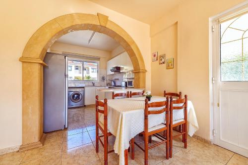 a kitchen and dining room with a table and chairs at Hadjios Valley in Mazotos