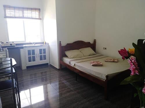 a small bedroom with a bed and a kitchen at Seaview Mansion Apartment 1 in Dalaguete