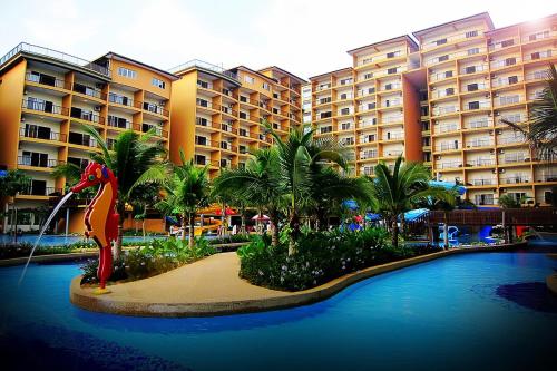 a resort with a statue of a horse next to a pool at Cozy Escape @ Gold Coast Morib in Morib