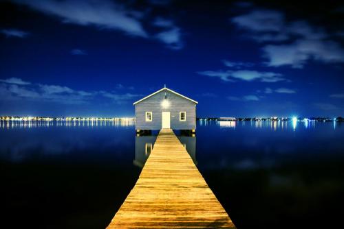 a house on a dock in the middle of the water at Perth City Retreat - parking, pool, self contained in Perth