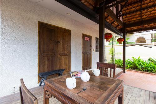 a wooden table and chairs on a patio at BTC Hua Hin Home managed by BTC Boutique Resort in Hua Hin