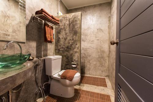a bathroom with a toilet and a sink at Na Siam Guesthouse in Phuket