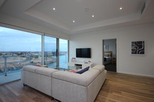a living room filled with furniture and a large window at Wallaroo Marina Apartments in Wallaroo