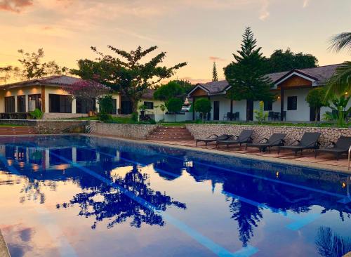 a swimming pool in front of a house at Casa de Moalboal in Moalboal