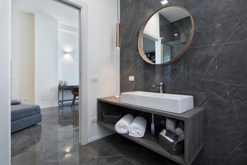 a bathroom with a sink and a mirror at Suite Vogue Stazione in Voghera