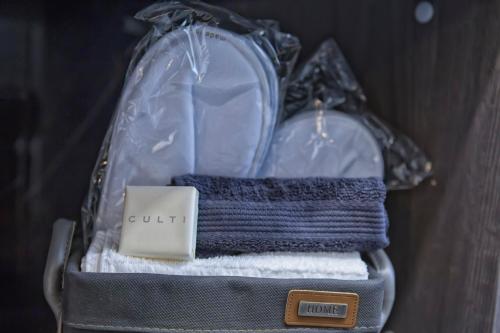 沃蓋拉的住宿－Suite Vogue Stazione，装满毛巾的袋子和装有卡片的手提箱