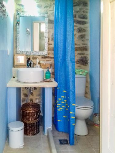 a bathroom with a sink and a toilet at Private studio in historic house in Lástros