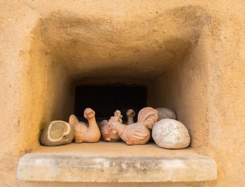 a group of ceramic animals sitting on a shelf at Private studio in historic house in Lástros