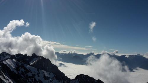 a view of a mountain with clouds in the sky at Pension Trillerhof in Ramsau am Dachstein