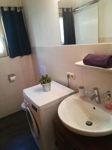 a bathroom with a sink and a toilet and a mirror at Telfeshof in Fiss