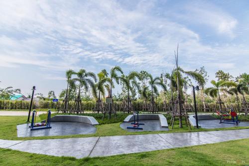 a park with three slides and a playground at Sea View Residence in Cha Am