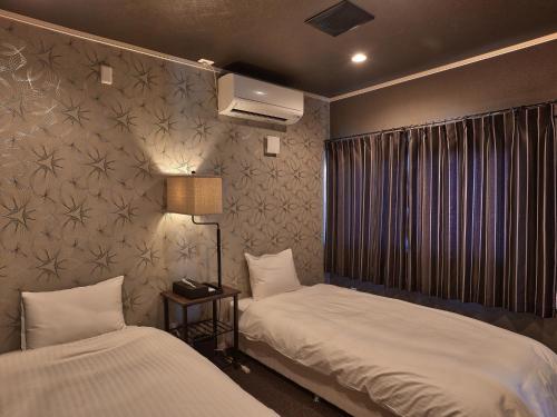 Una cama o camas en una habitación de Sesoko Villa