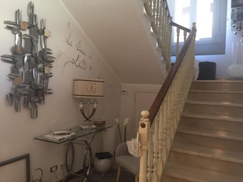 a room with a staircase with utensils on the wall at Casa Stella in Bastia Umbra