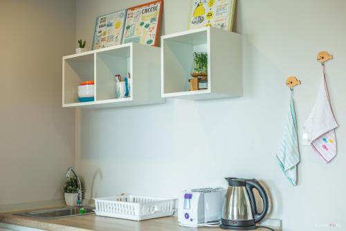 a kitchen counter with white cabinets on the wall at Sea View Residence in Cha Am
