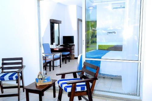 a room with chairs and a sliding glass door at Voyager Beach Resort in Mombasa