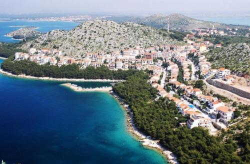 an aerial view of a resort on a hill with the ocean at Lavender Apartments in Drage