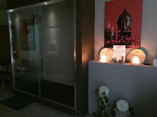 a bathroom with a shower with candles on a shelf at Grand Hotel Stella Maris Italia in Palmi