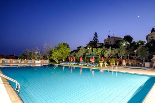 a large swimming pool at a resort at night at Hadjios Valley in Mazotos