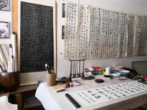 an office with a desk with writing on the wall at Zhangjiajie Jijiehao Inn in Zhangjiajie