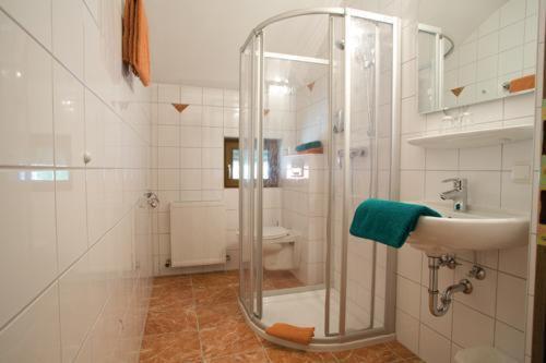 a bathroom with a shower and a sink at Hotel-Pension Schwaighofen in Eugendorf