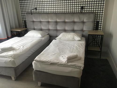 Letto o letti in una camera di Hotel Pomarańczowa Plaża