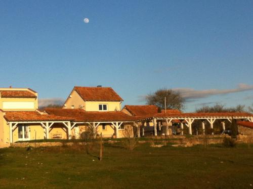 a building with red roofs with the moon in the sky at Junior Suite Le Pied de Mulet in Brouchaud