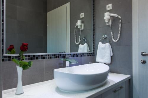 a bathroom with a white sink and a mirror at Villa Palladium in Makarska