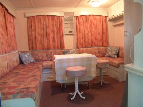 a living room with a couch and a table at Camping Cases in Les Cases d'Alcanar