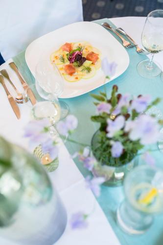 a table with a plate of food and flowers on it at IMbery Hotel & Restaurant Hinterzarten in Hinterzarten