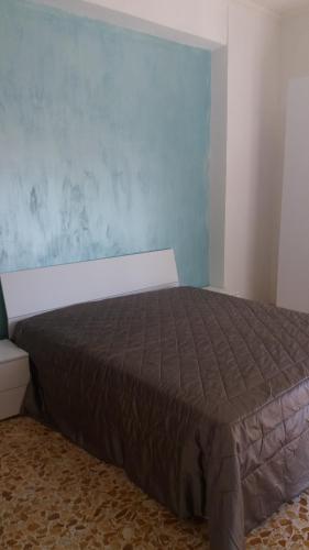a bedroom with a bed with a blue wall at Vient e mare (Sea wind) in Torre Annunziata