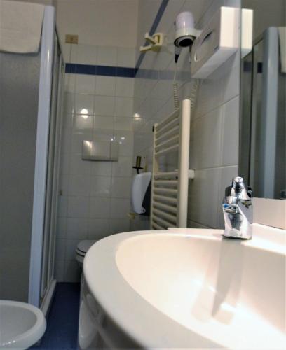 a bathroom with a sink and a toilet at Hotel Posta in Cecina