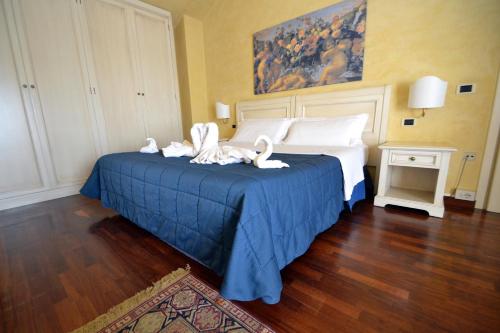 a hotel room with a bed with swans on it at Hotel Posta in Cecina