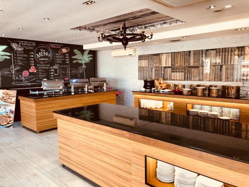 a restaurant with a counter with plates on it at Grand Amisos Hotel in Samsun