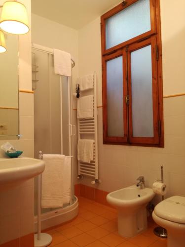 a bathroom with a sink and a toilet and a window at Dimora Pieri in Florence