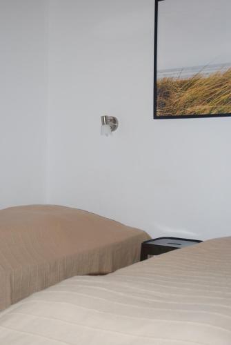 a bedroom with a bed and a mirror on the wall at Adventure Park Apartments in Ringkøbing