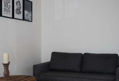 a living room with a couch and a candle on a table at Adventure Park Apartments in Ringkøbing