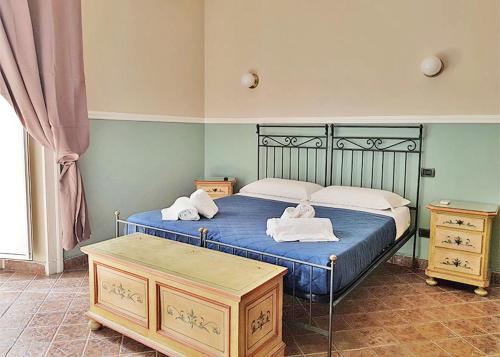 a bedroom with two beds with towels on them at B&B Delle Palme in Naples