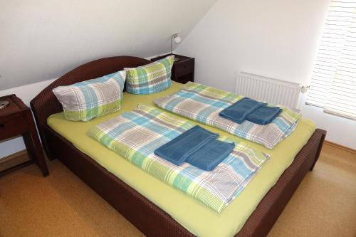 a bed with two pillows on top of it at BORKUMUNTERKUNFT - WOH2 - IM HERZEN DER INSEL in Borkum