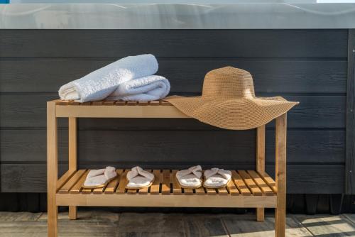 a hat and towels and shoes on a shelf at Eiriana Luxury Suites in Plaka Milou