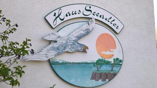 a sign on the side of a building with a bird at Hotel-Pension Seeadler in Prerow