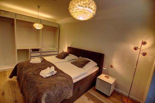 a bedroom with a bed with two towels on it at Plenus Riverloft in Bremen