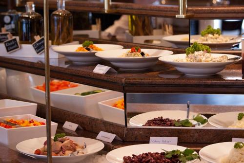 a buffet of different types of food on display at Best Western Plus Plaza Hotel Darmstadt in Darmstadt