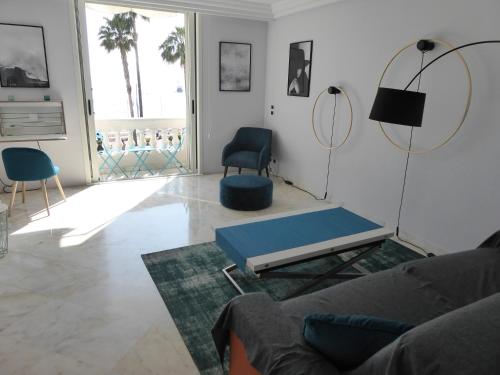 a living room with a couch and a chair at Residence Palais Miramar in Cannes