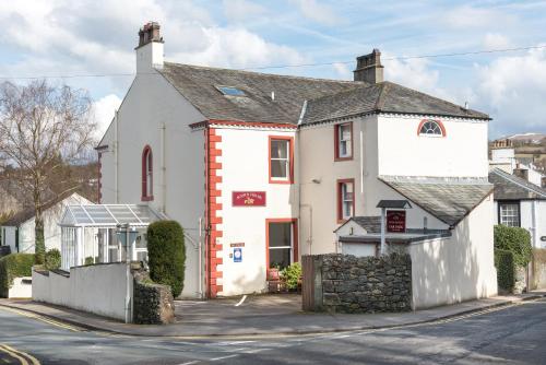 a white building on the side of a street at Acorn House in Keswick
