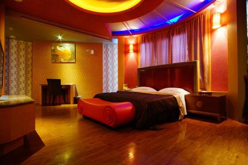 a bedroom with a bed in a room with purple lights at Water City Motel in Daya
