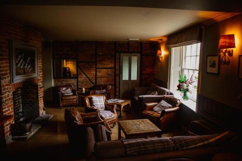 a living room with couches and chairs and a window at The Hawk Inn in Andover