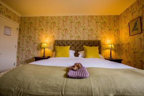 a bedroom with a bed with a teddy bear on it at The Hawk Inn in Andover